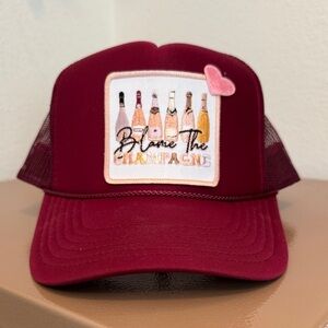 Blame the Champagne Trucker Hat